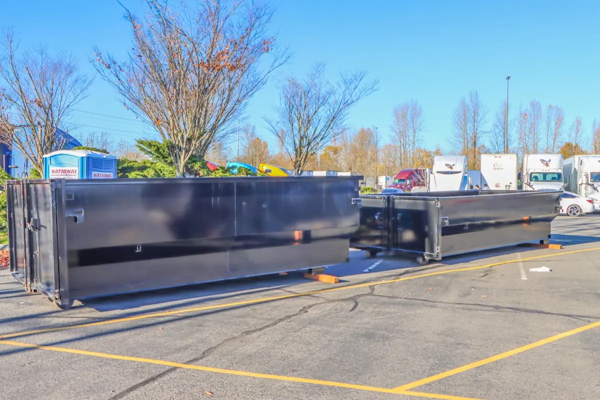 Professional dumpster rental service with roll-off container on residential driveway in McAlester